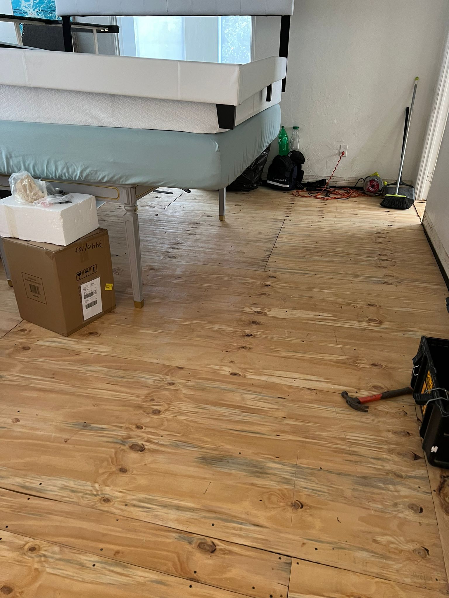 New 3/4" plywood base installed over the moisture barrier, ready for waterproof vinyl flooring, Miami Beach