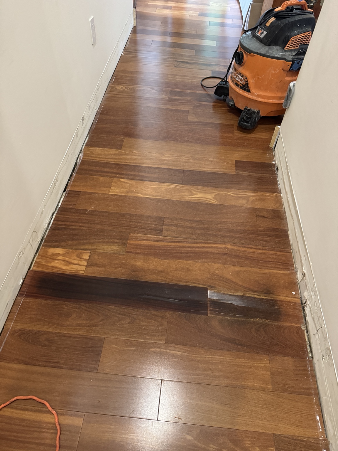 Solid hardwood flooring during the repair and plank-matching process.