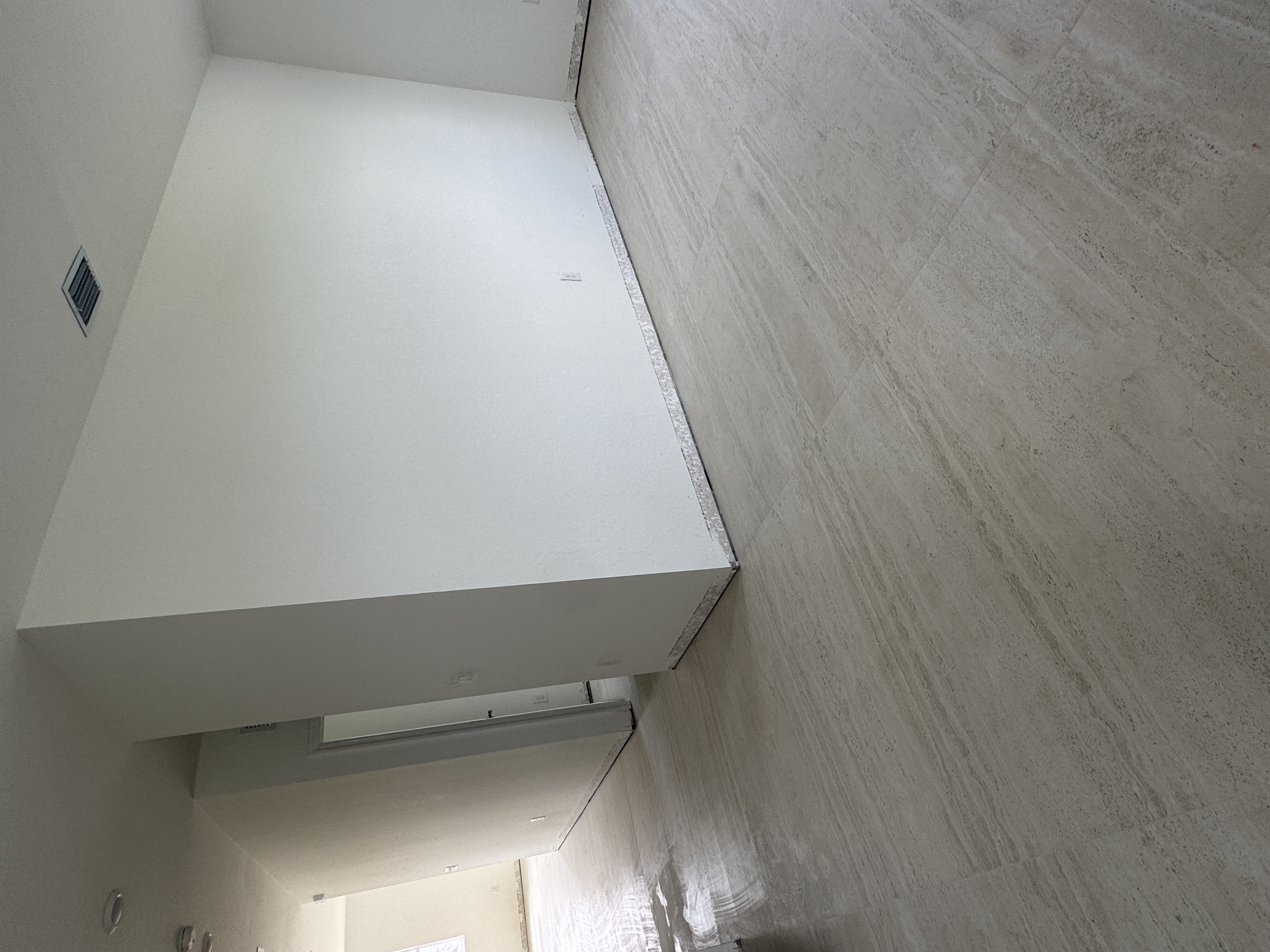 Staircase wall before baseboard installation in a Miami home