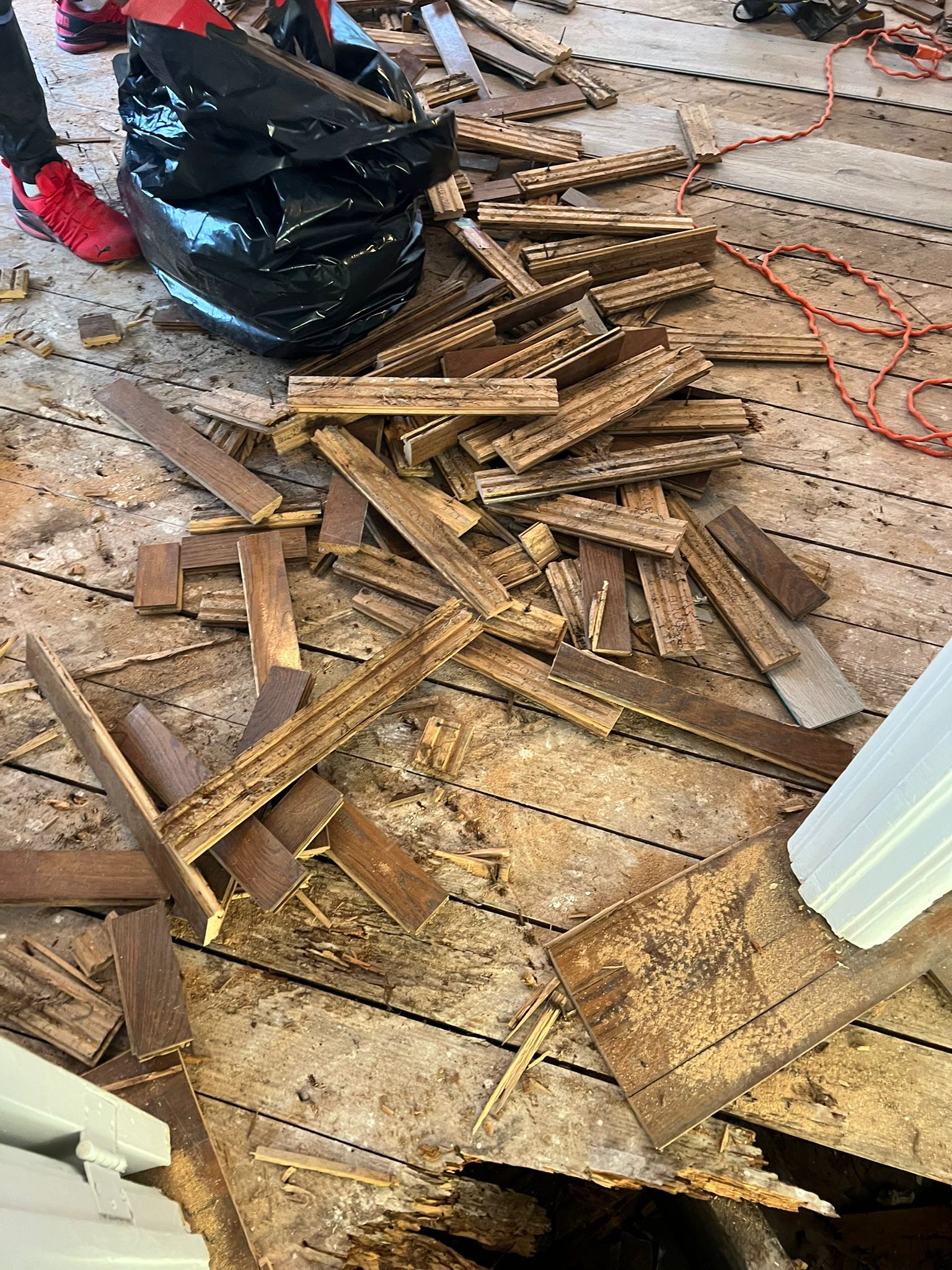 Removed hardwood flooring debris cleared during demolition, Miami Beach repair project