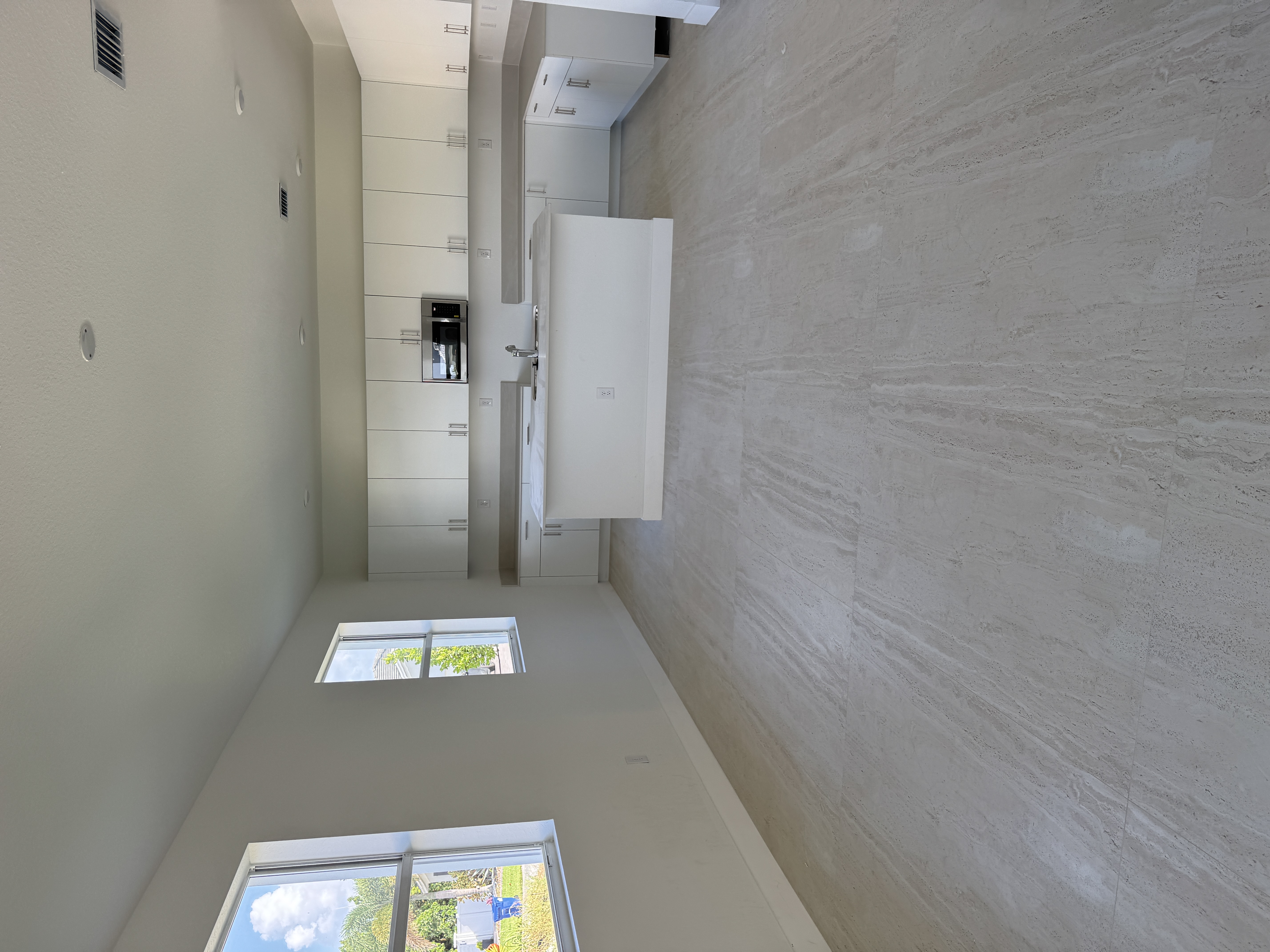 Kitchen wall-to-floor junction with no baseboard trim before installation, Miami