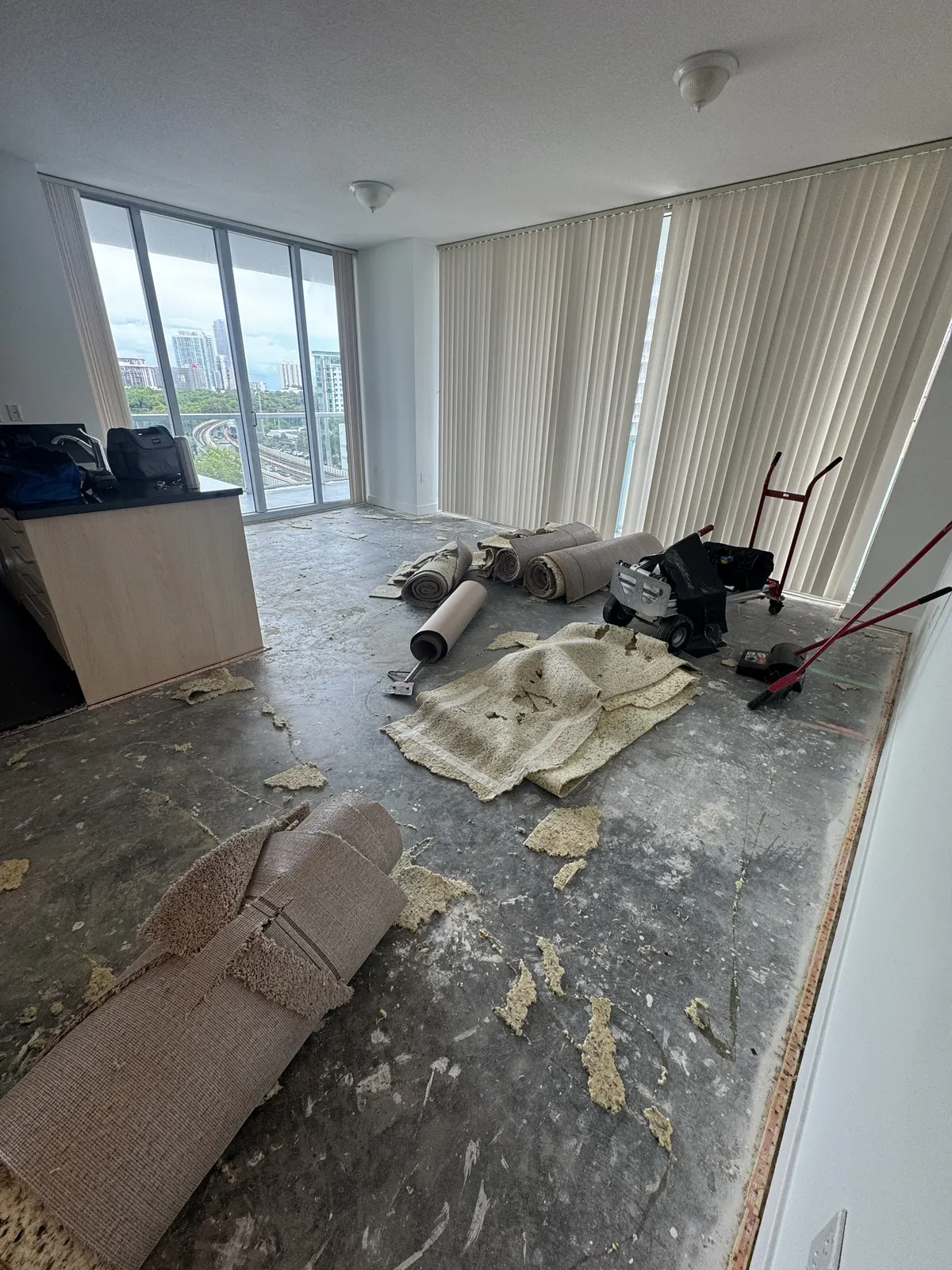 Existing carpet being removed during floor preparation at Axis on Brickell in Miami.