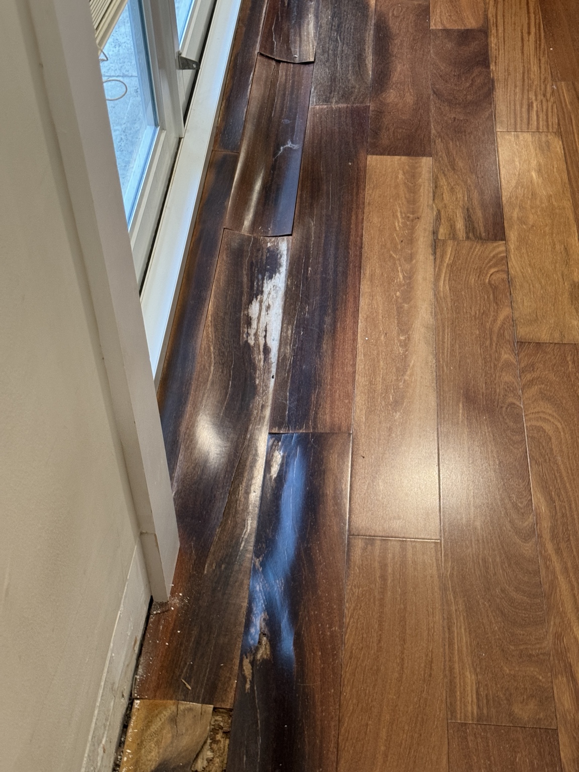 Darkened and deteriorated solid Brazilian Cherry planks identified for repair.