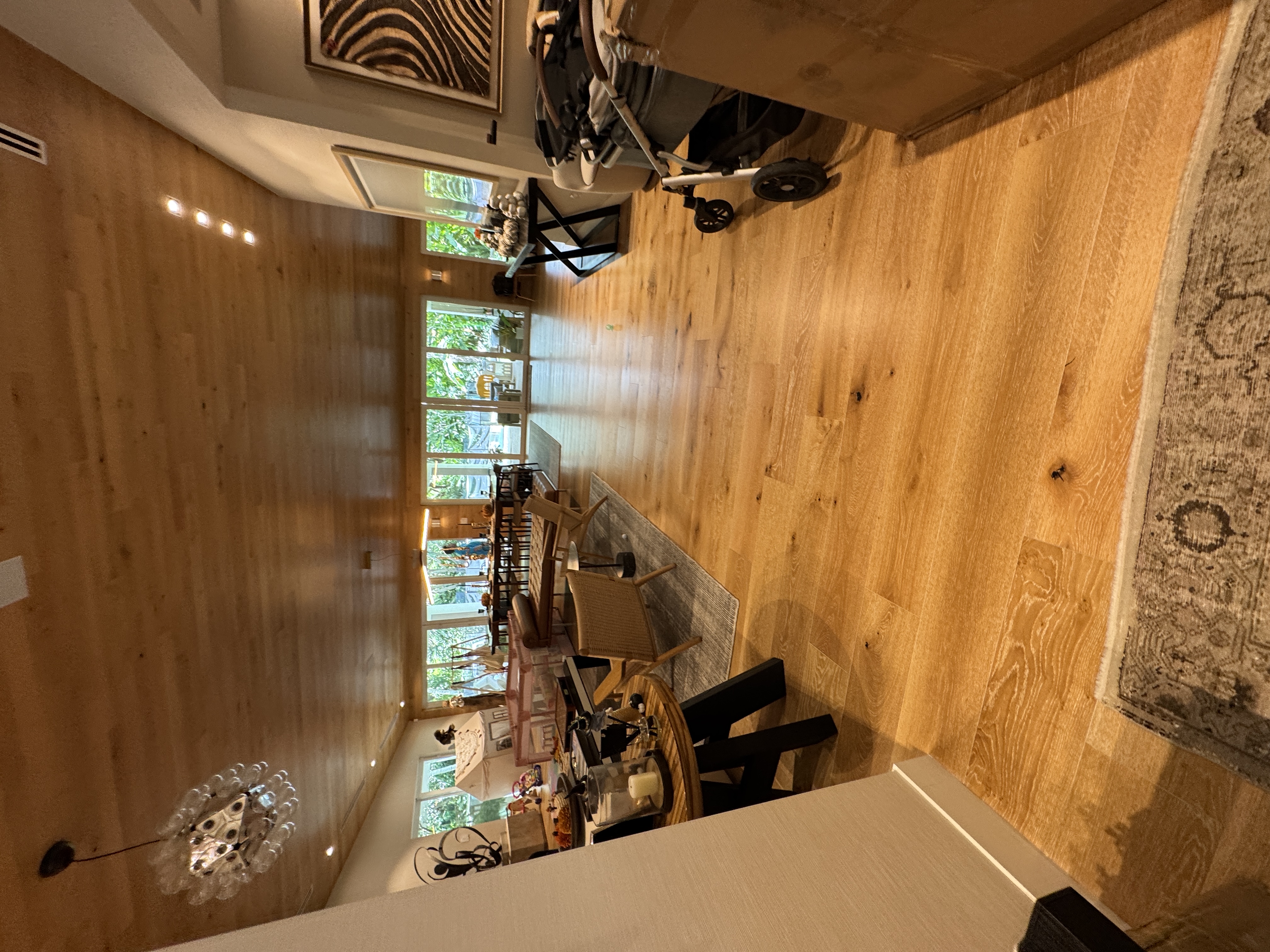 Completed dining room with engineered wood flooring in a Pinecrest, FL home.