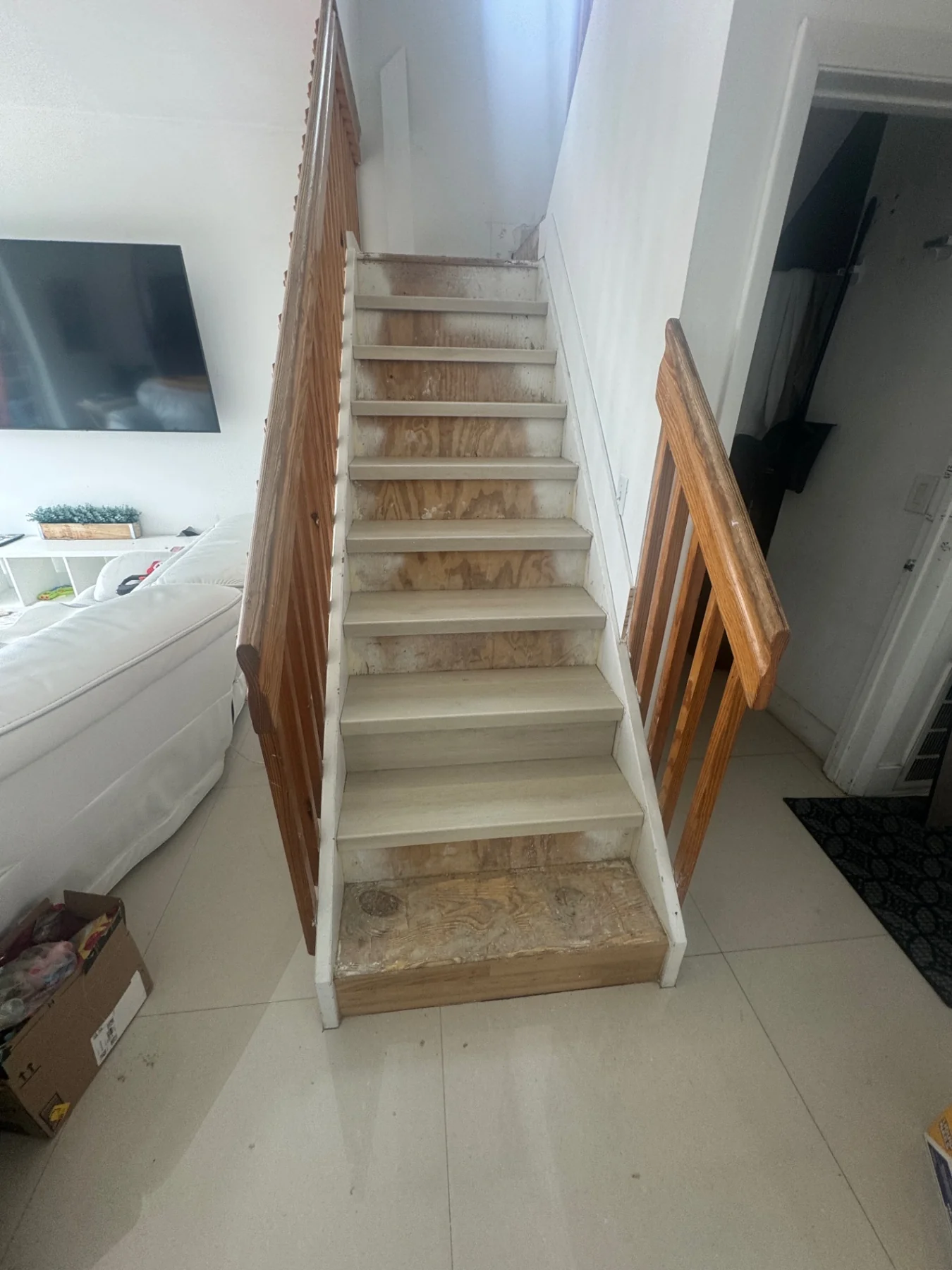 Original staircase before the first-step extension and new finish.