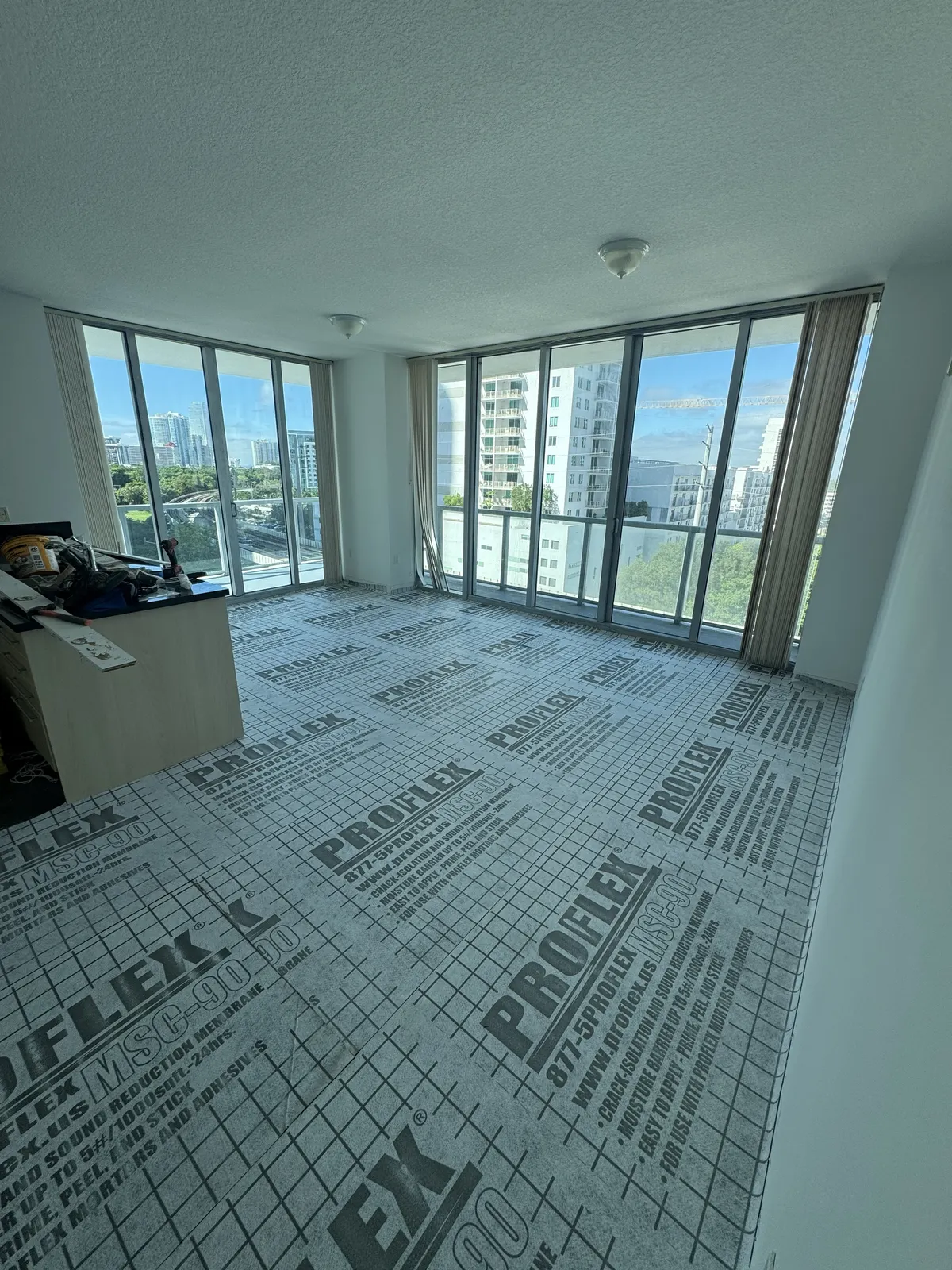 ProFlex MSC-90 underlayment installed in the living and dining area at Axis on Brickell, with a Miami city view.