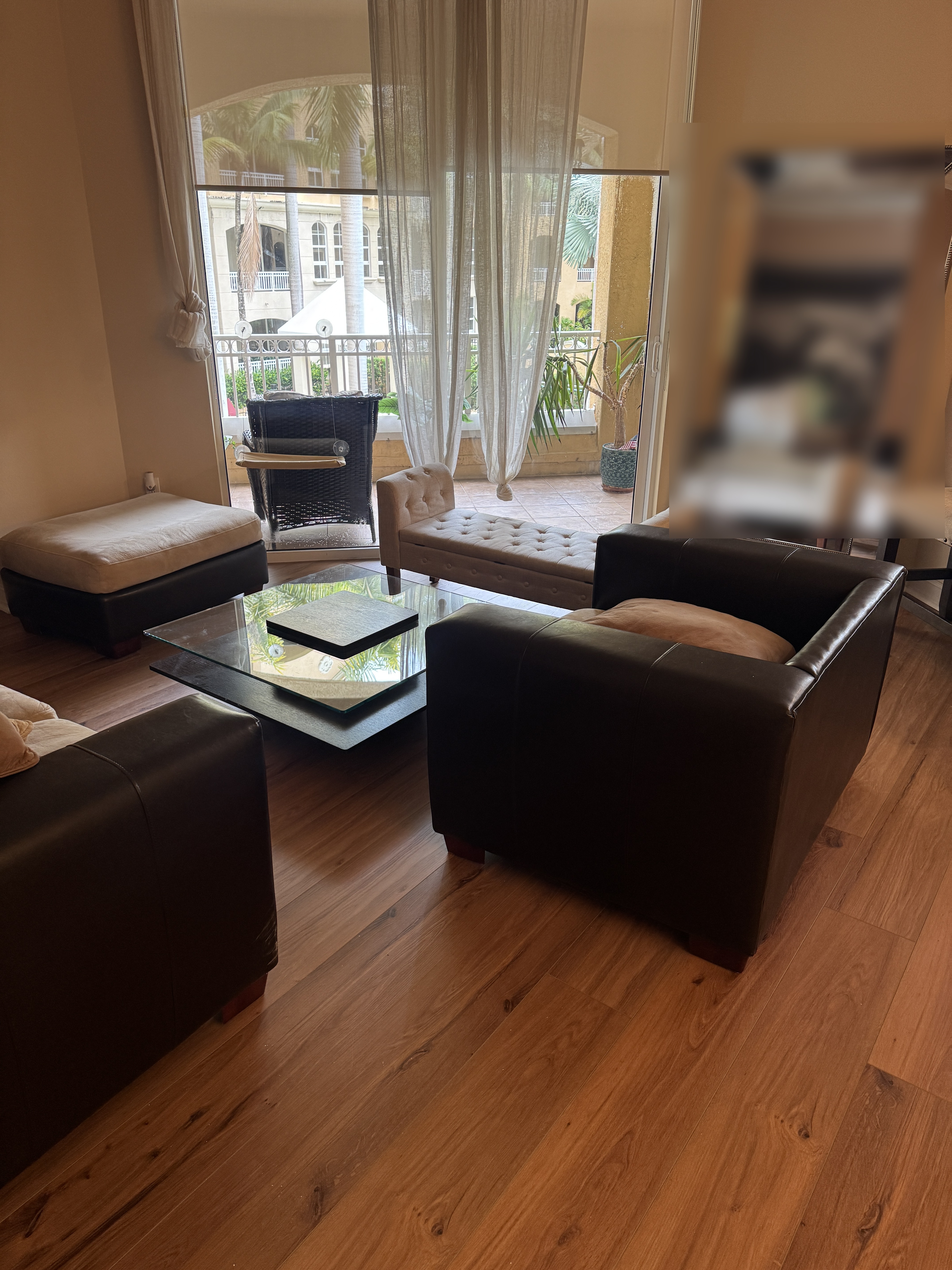 Detail of vinyl wood-look flooring around the living room seating area in an Aventura, FL condo.