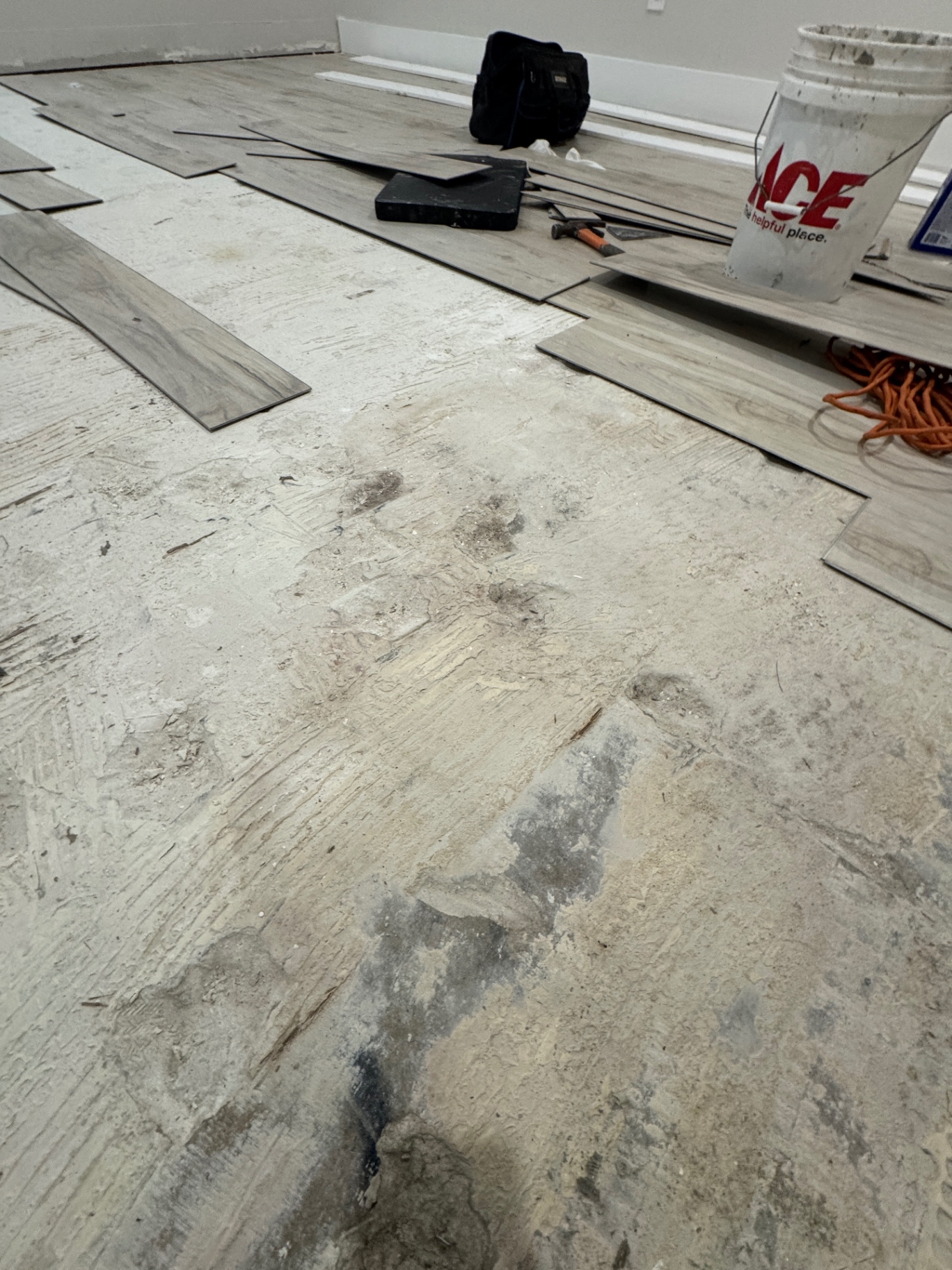 Flooring planks removed during a residential floor repair project, work area prepared for reinstallation.