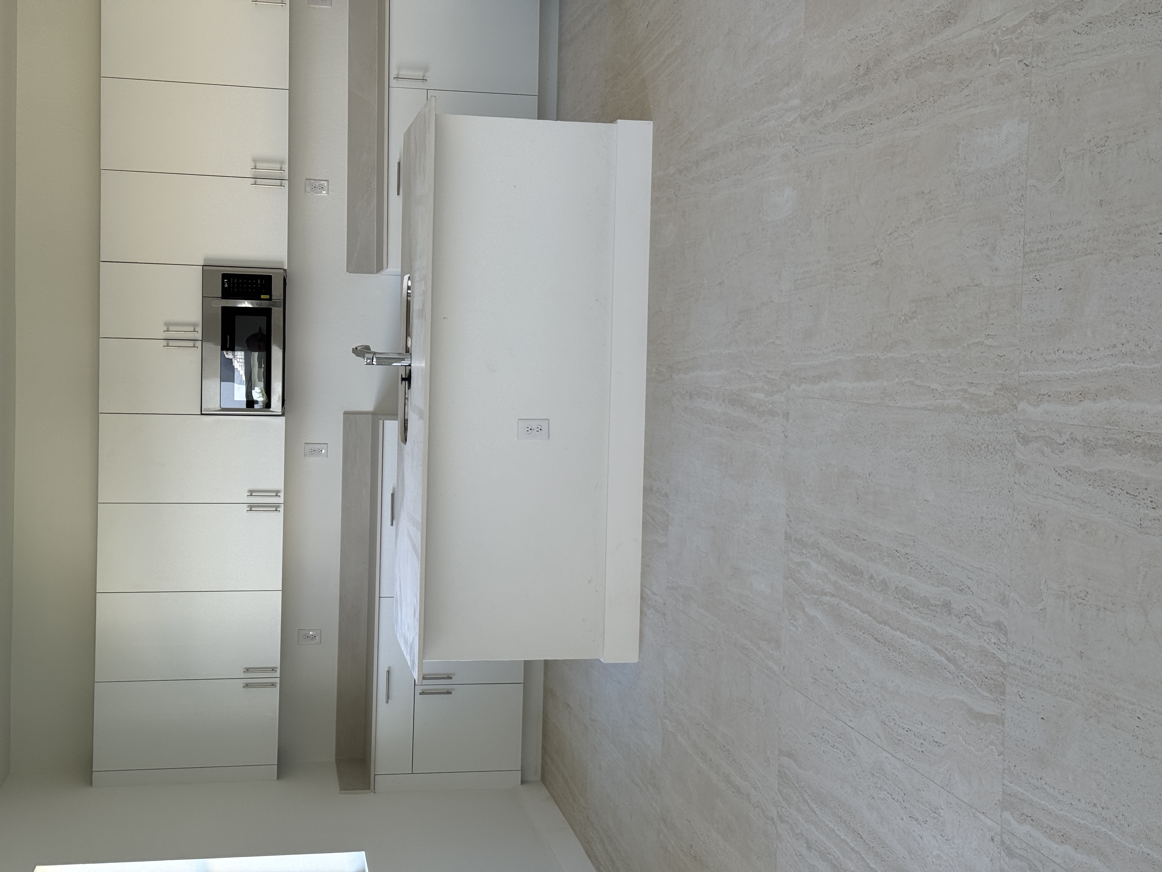 Finished baseboard trim at the base of kitchen cabinetry, Miami interior trim installation