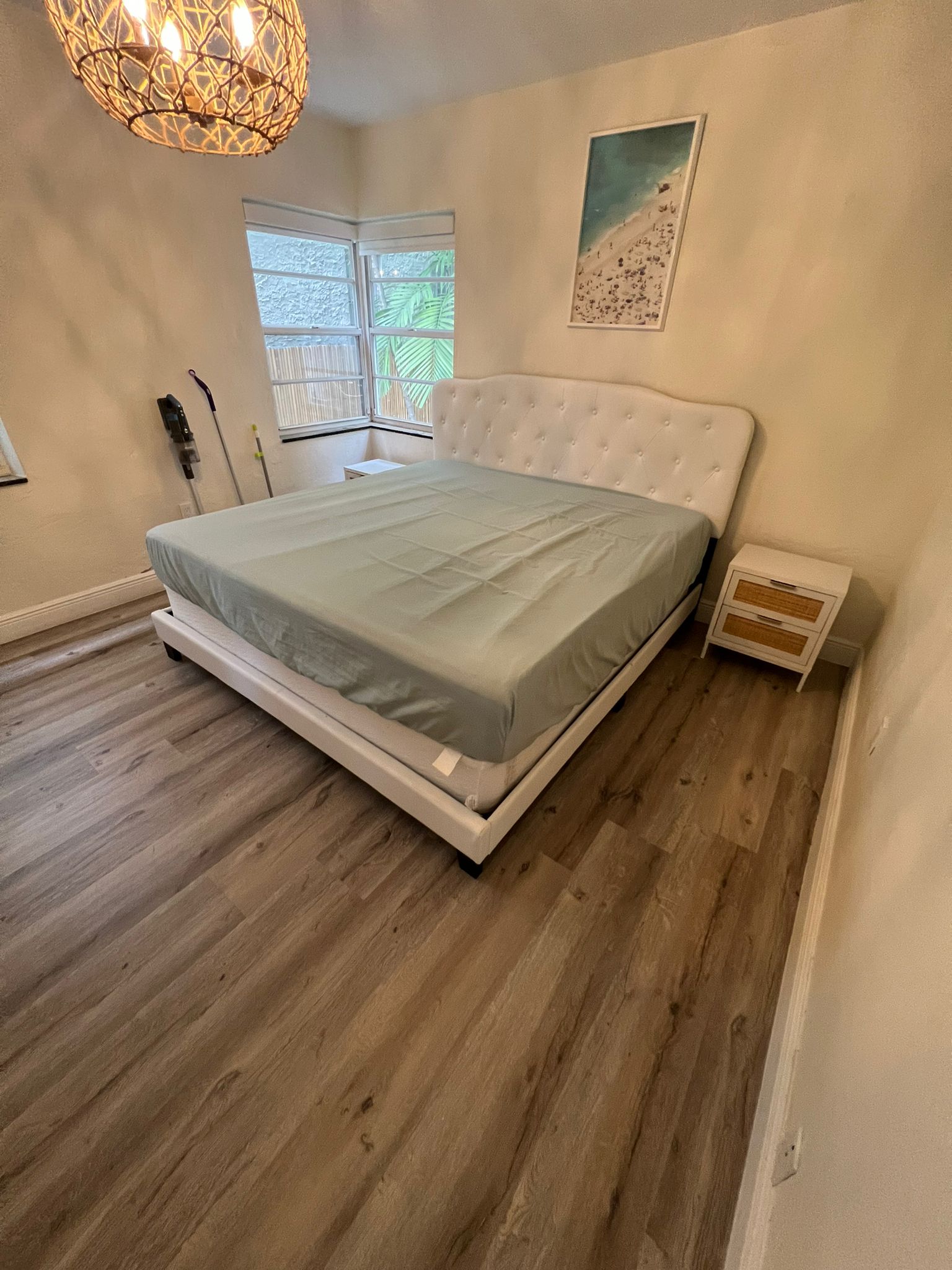 Second bedroom with finished waterproof vinyl flooring after full repair, Miami Beach home