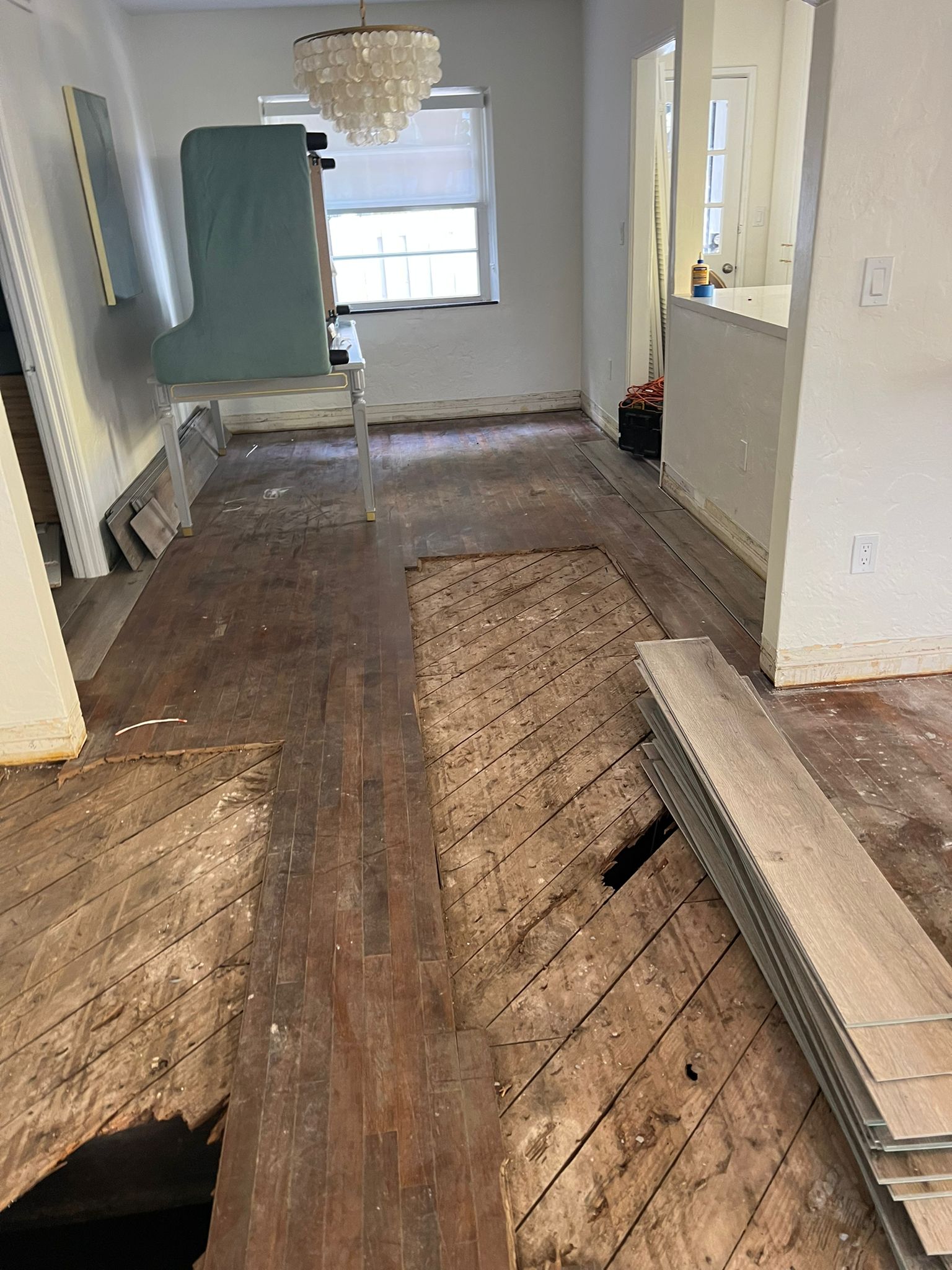 Flooring demolition in progress with damaged boards cleared before subfloor repair, Miami Beach