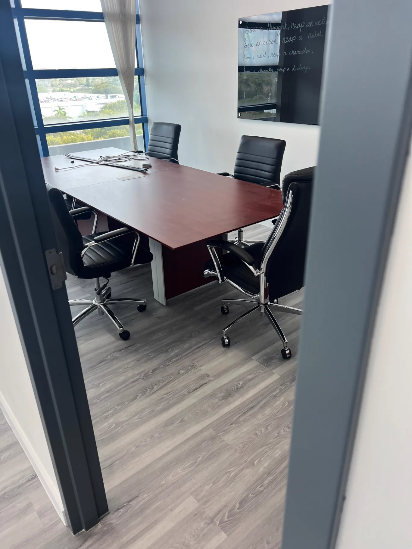 Corporate conference room in Miami with light gray wood-look flooring installed by Colors Wood Floor Corp.