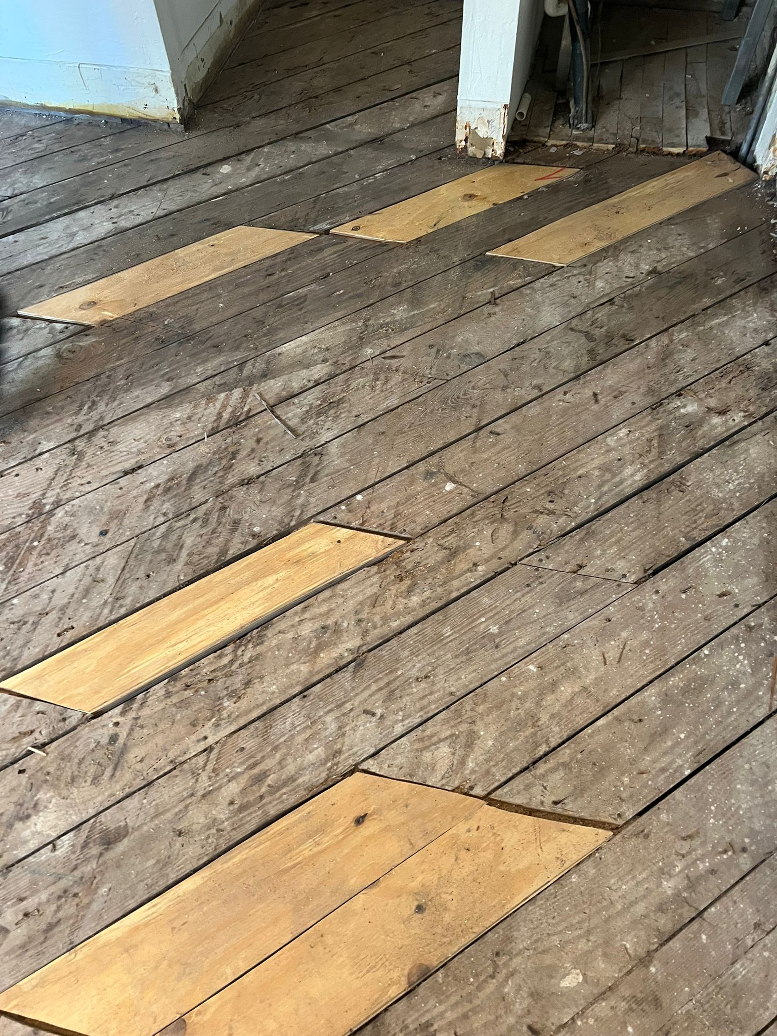 Detail of new subfloor patches cut and fitted into the repaired area, Miami Beach