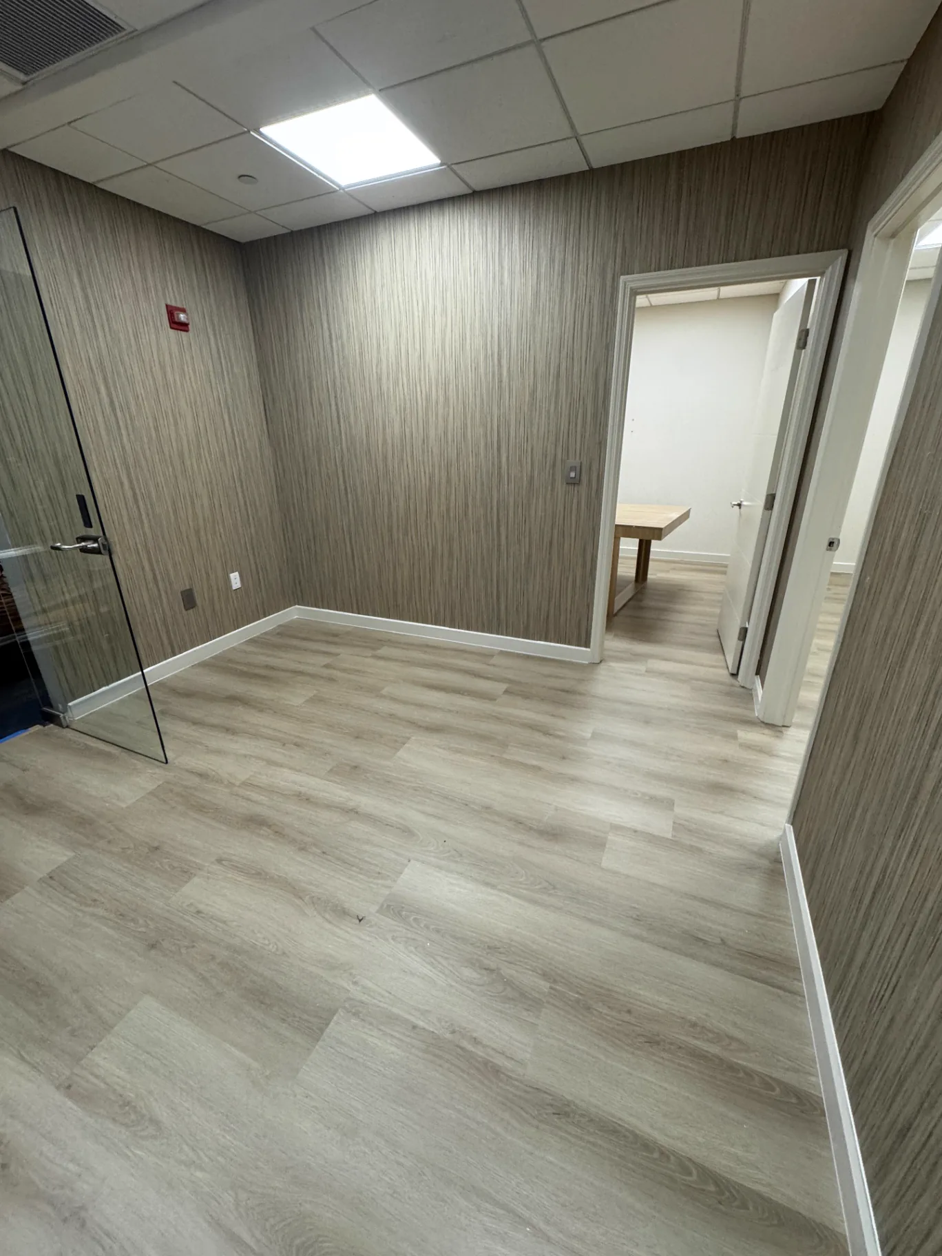 Private office in Miami finished with a lighter warm oak wood-look floor — commercial installation by Colors Wood Floor Corp.
