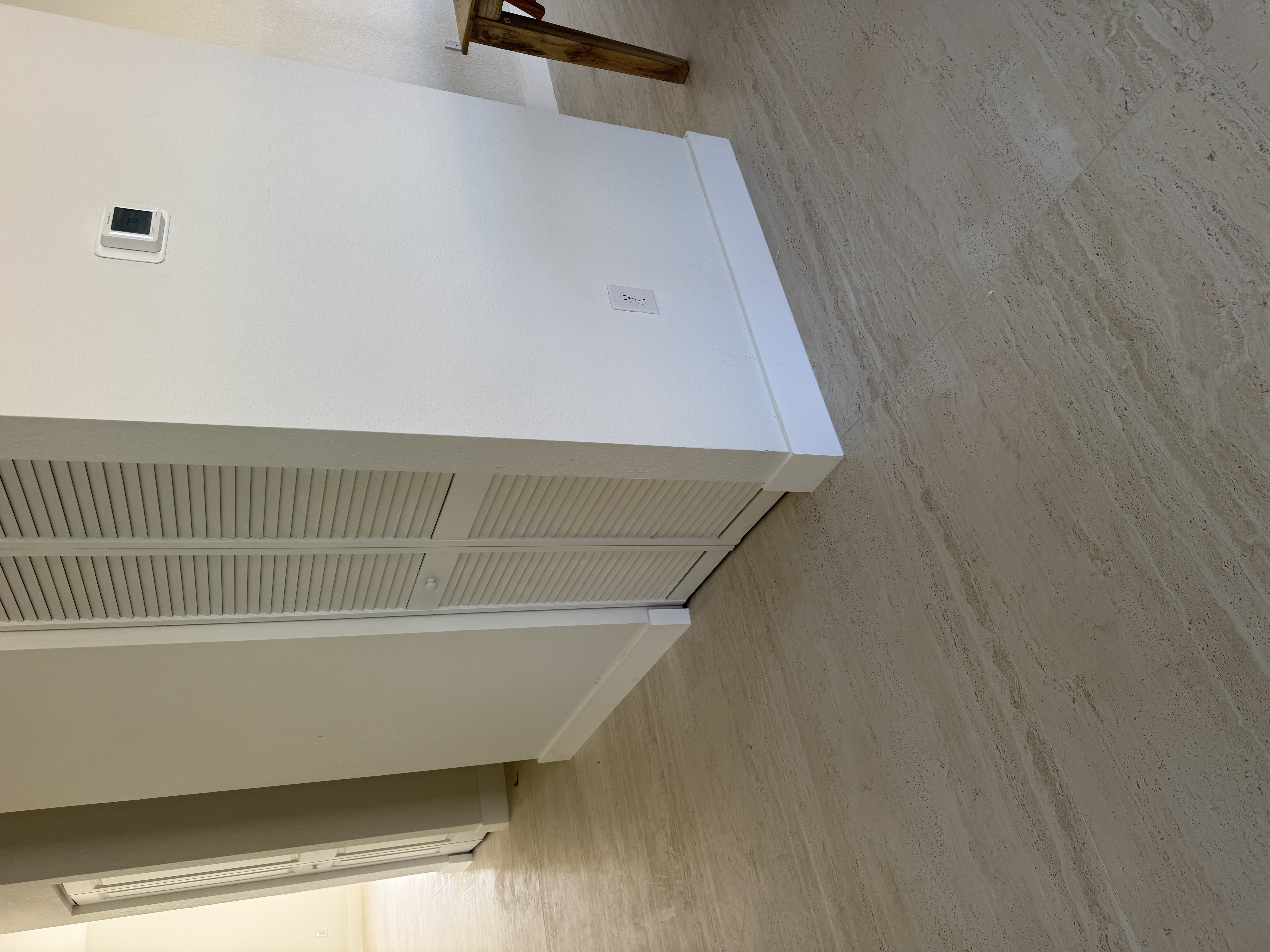 Clean, finished baseboard line around a kitchen island after installation, Miami home