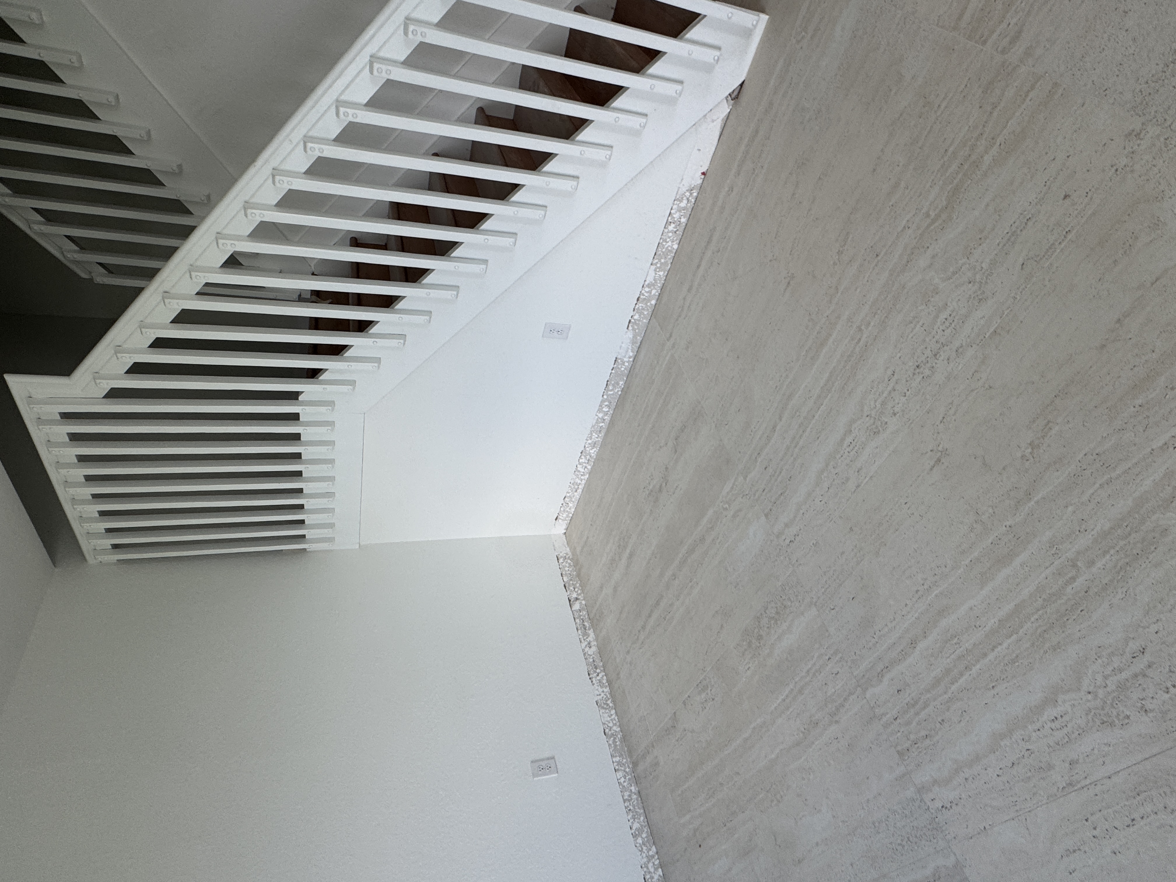 Detail of staircase wall-to-floor junction with no baseboard trim yet, Miami home