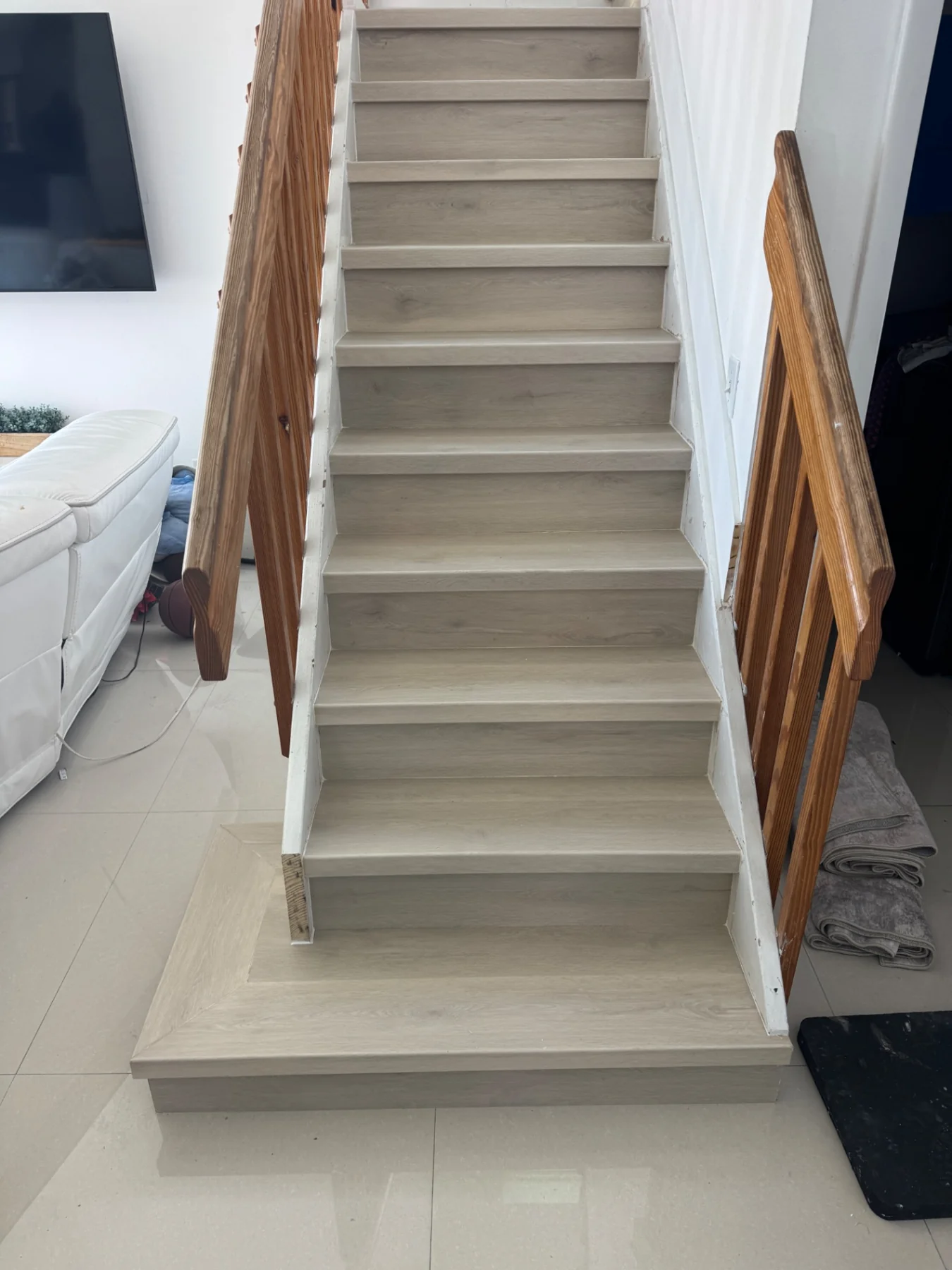 Light wood-look staircase finish completed by Colors Wood Floor Corp.