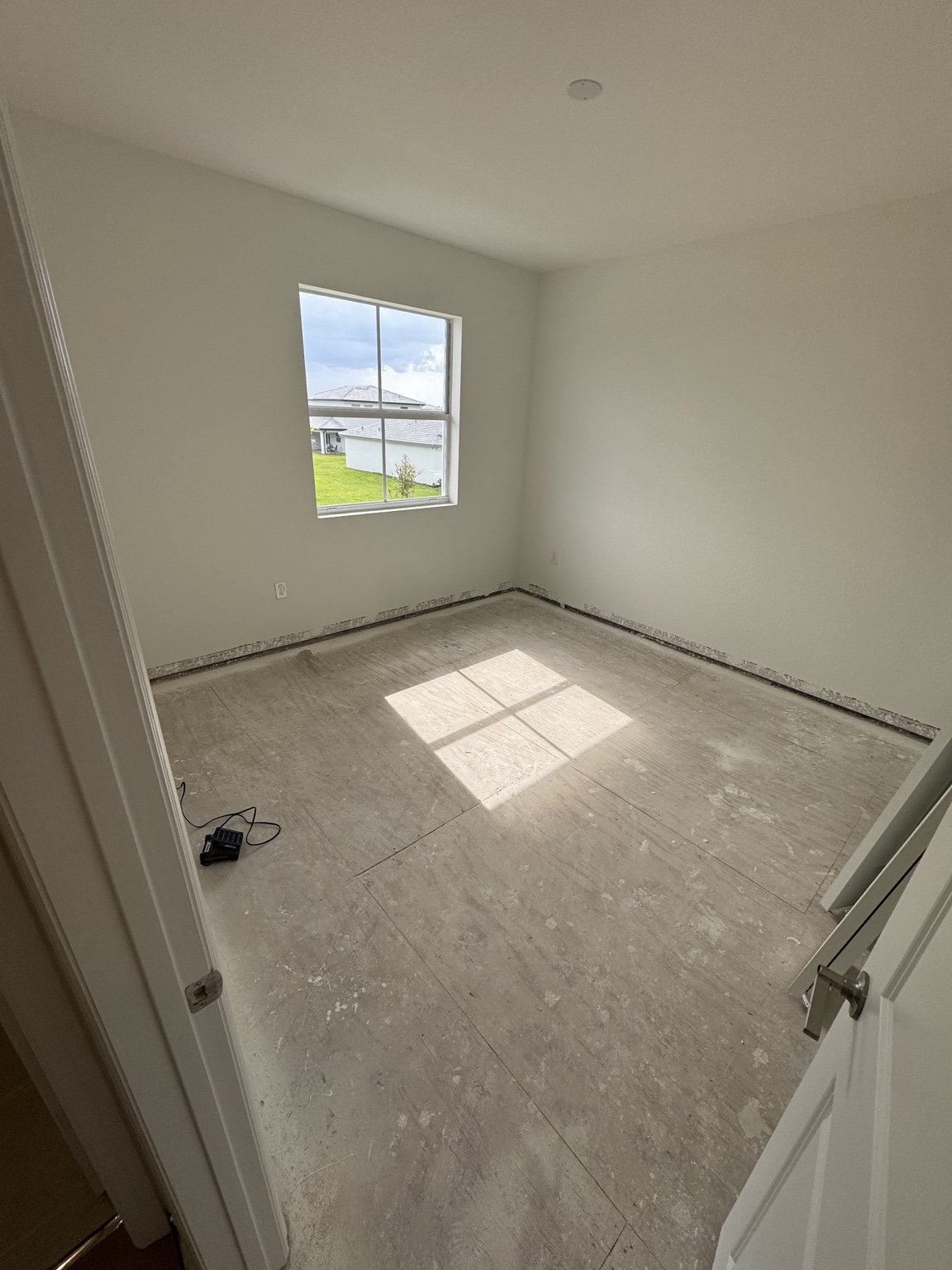 Bedroom during subfloor preparation before warm oak laminate flooring installation