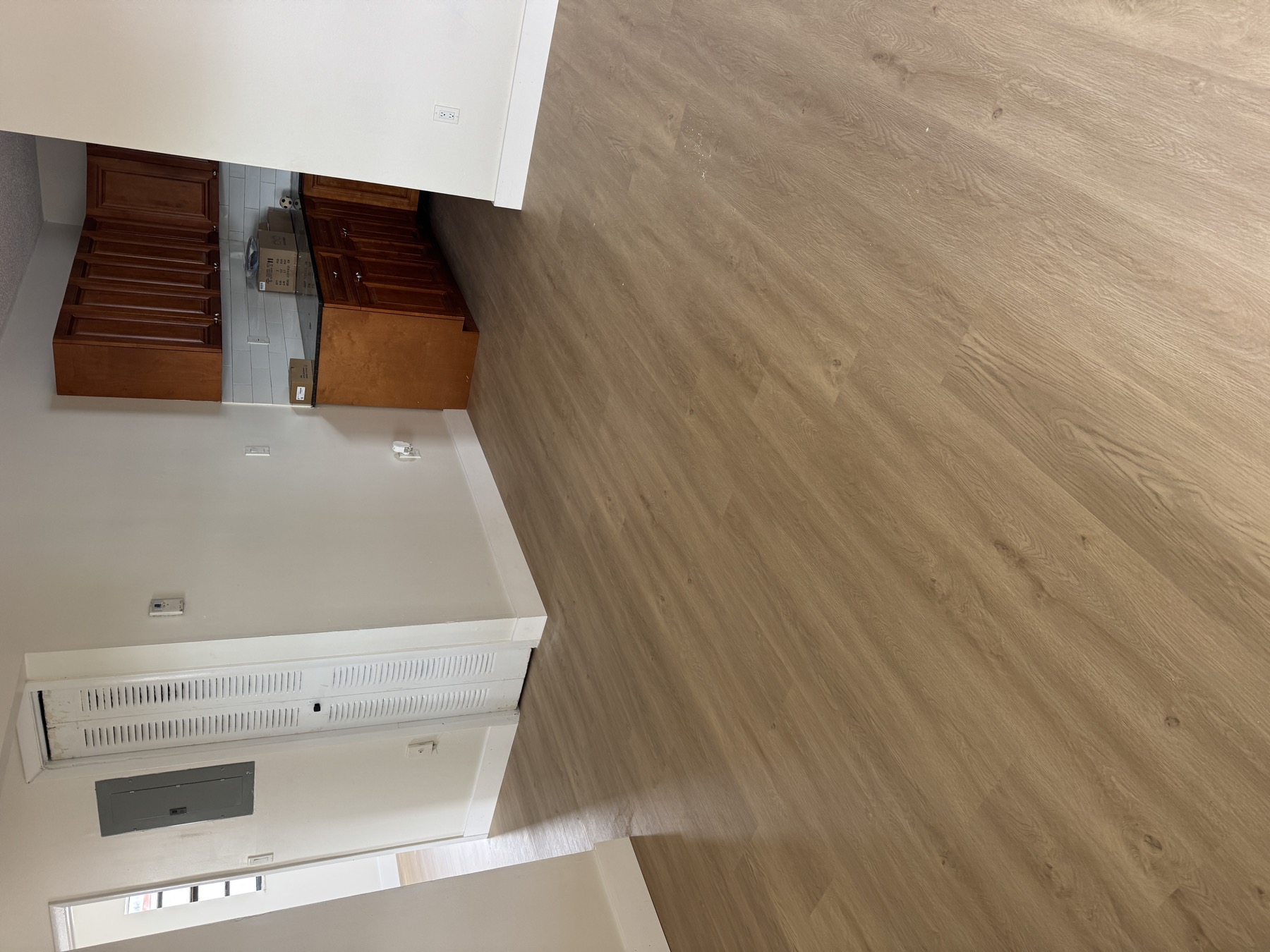 Continuous vinyl plank flooring running from the living area into the kitchen