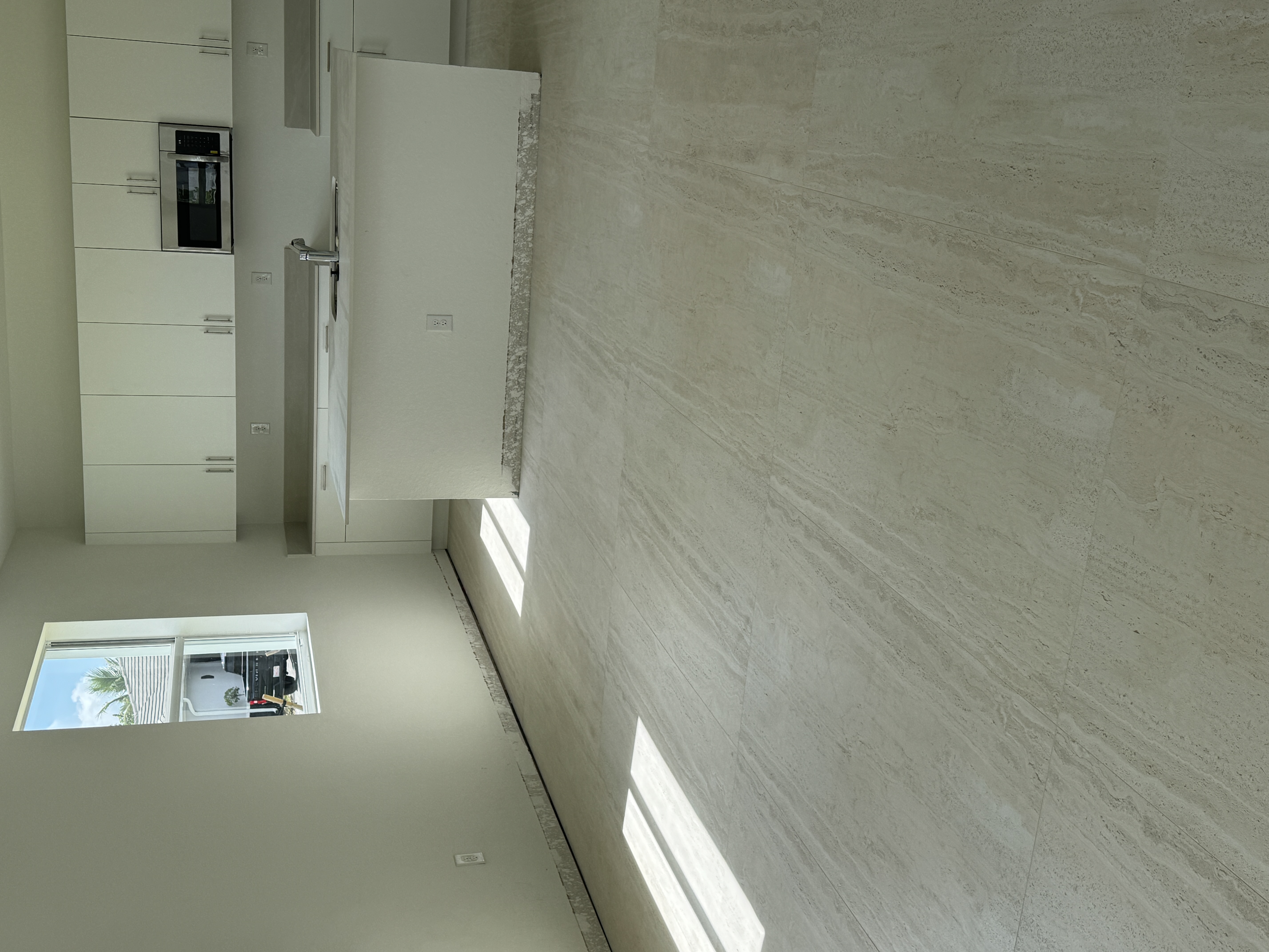 Kitchen cabinetry before baseboard installation, Miami home renovation