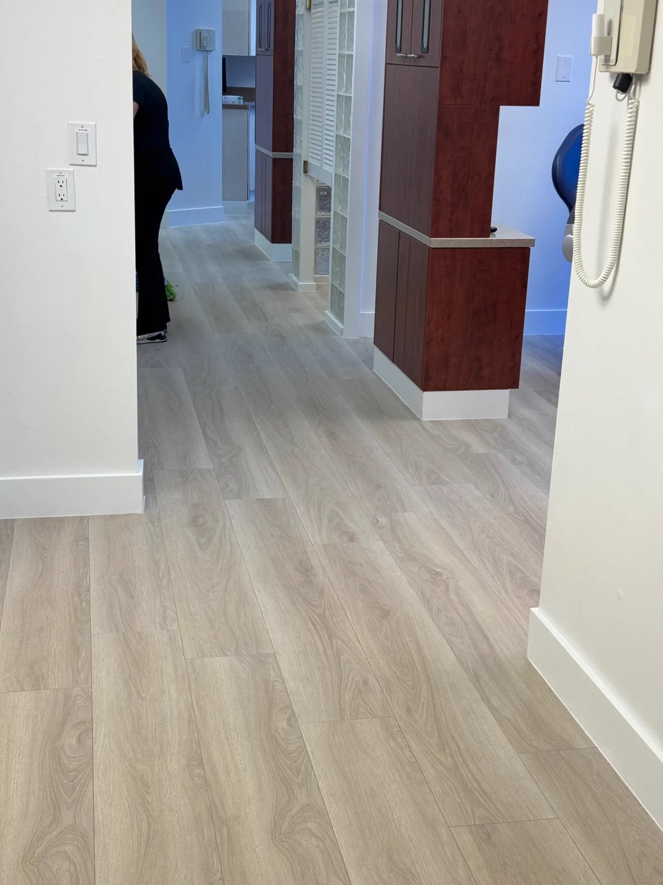 Second view of the completed dental office hallway in Miami with continuous commercial wood-look flooring installed by Colors Wood Floor Corp.