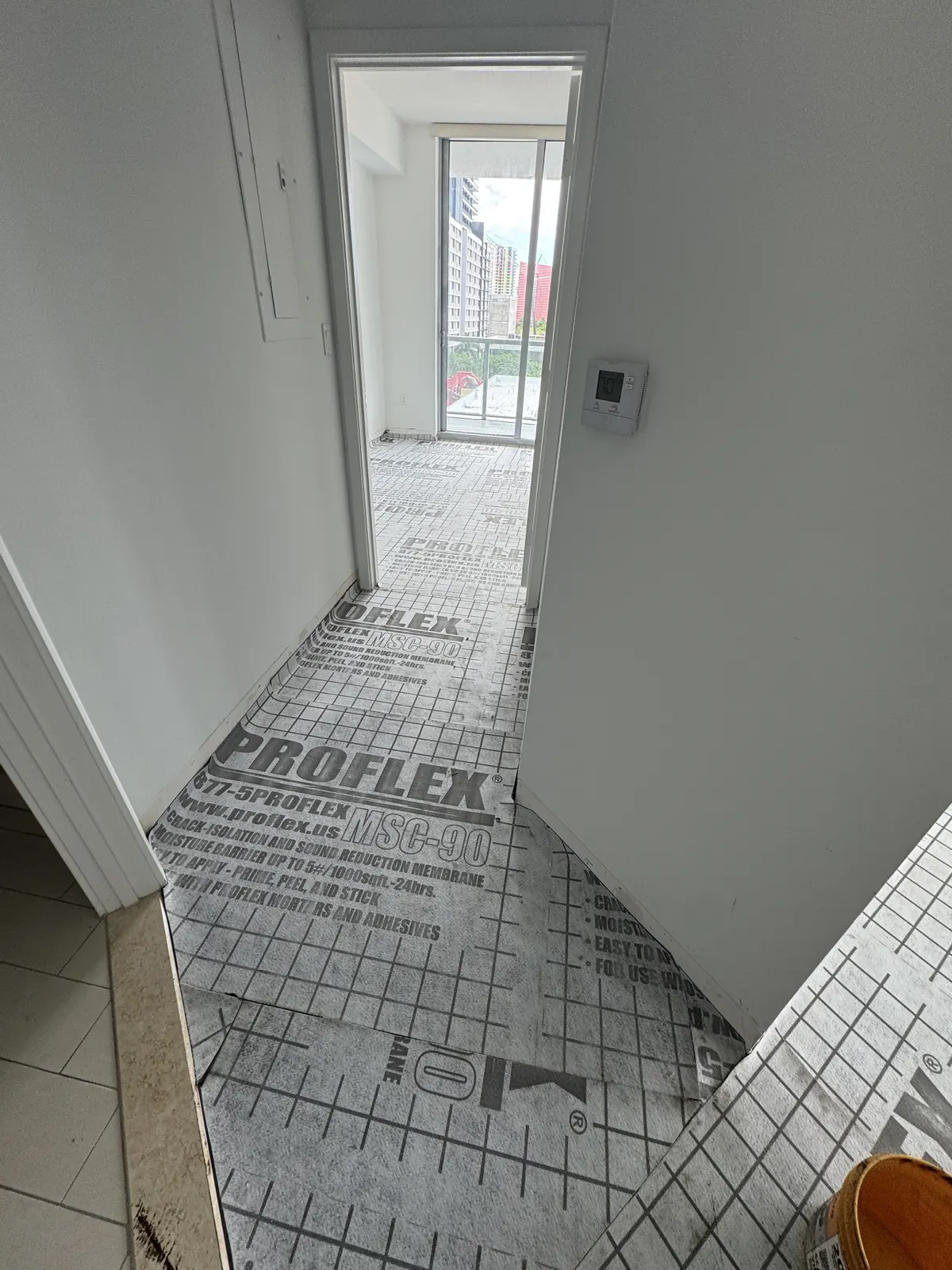 Second bedroom with completed light gray wood-look Rio Novo Villa Arcadio vinyl flooring and finished baseboards at Axis on Brickell.