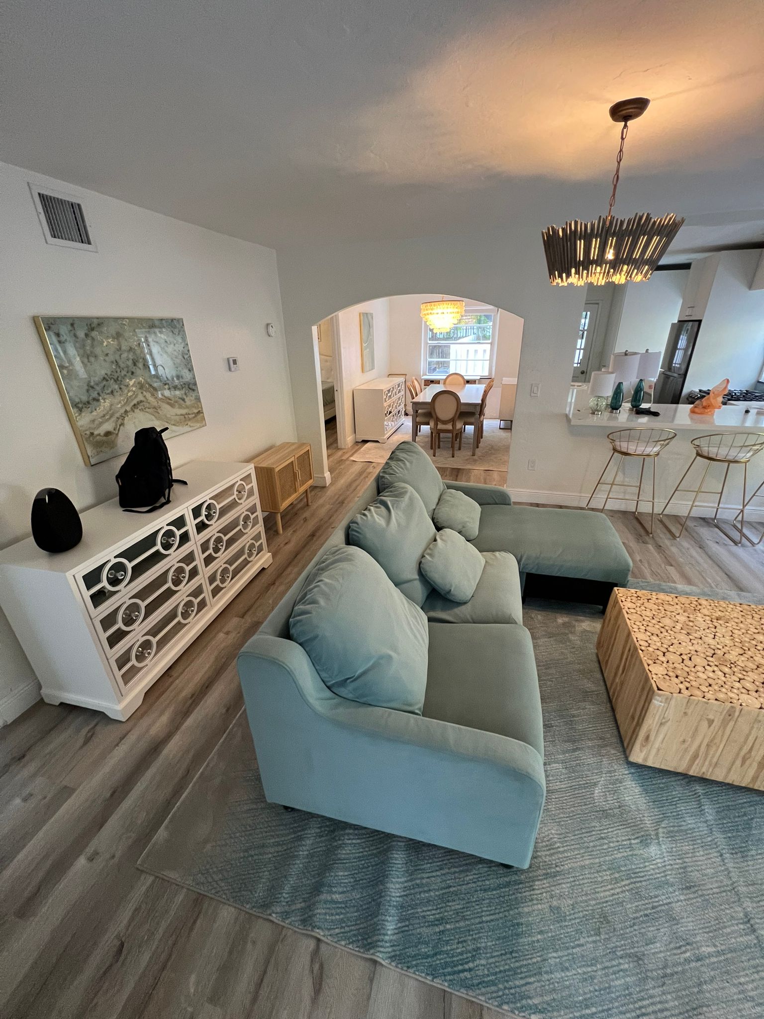 Finished living room with new waterproof vinyl wood-look flooring after subfloor repair, Miami Beach
