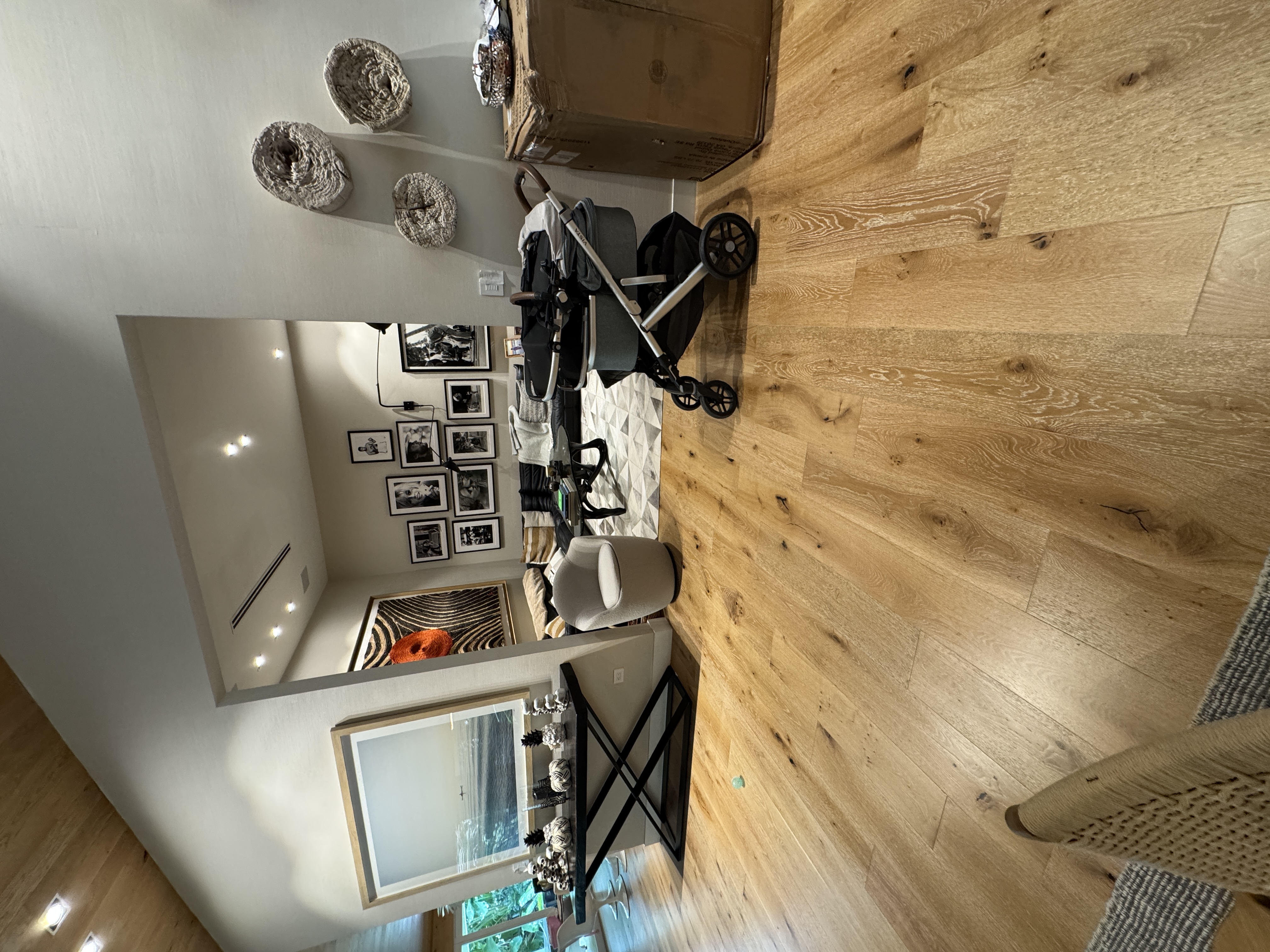 Completed living room by the sofa with engineered wood flooring in a Pinecrest, FL home.
