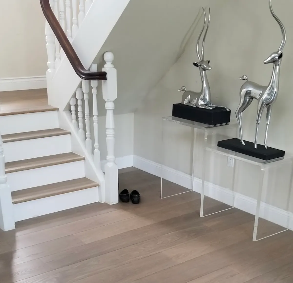 Staircase with wood treads matched to the wide-plank floor below, with white risers and baseboards, by Colors Wood Floor