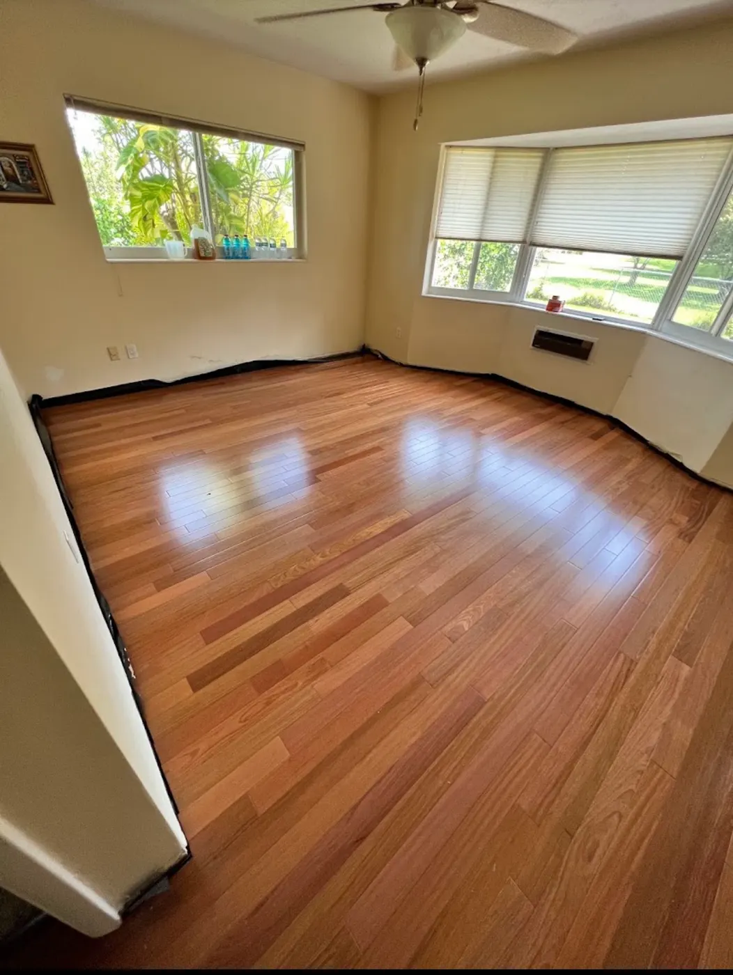 Finished new wood floor installed by Colors Wood Floor in the same bedroom